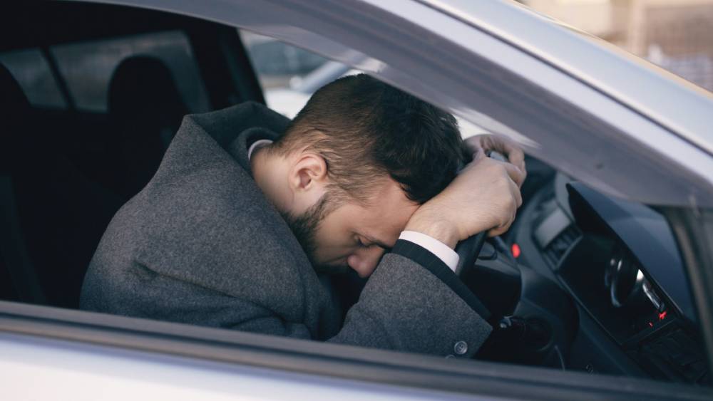 Driver looking ill while at the wheel of a car